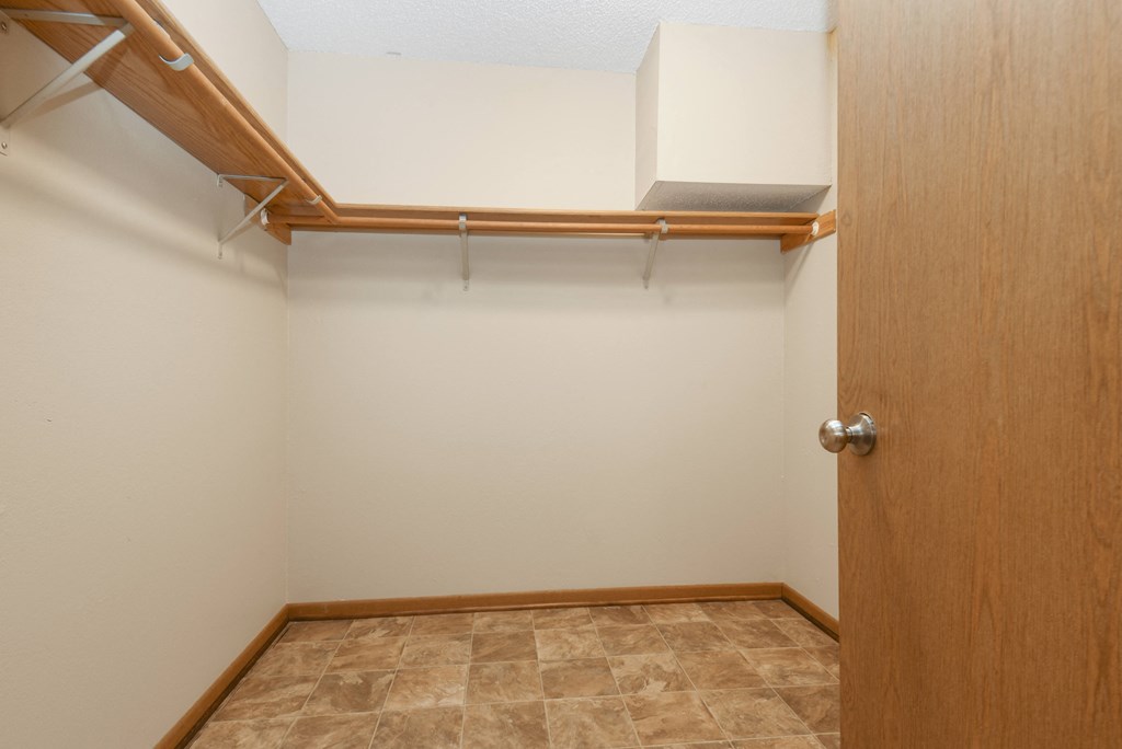 Anoka, MN Dellwood Estates Apartments. a large walk in closet in a bedroom with a tiled floor