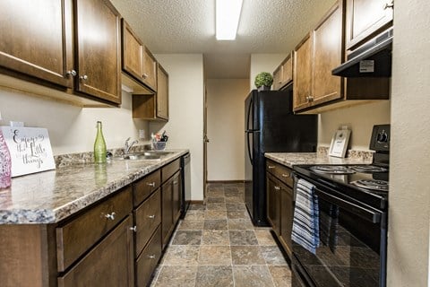 Bismarck, ND Eagle Sky I Apartments. A kitchen with black appliances