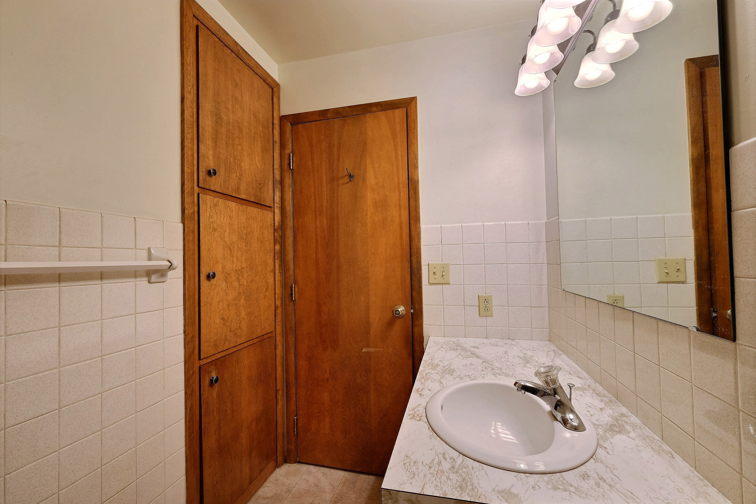 a bathroom with a sink and cabinet. Fargo, ND Emerald Apartments