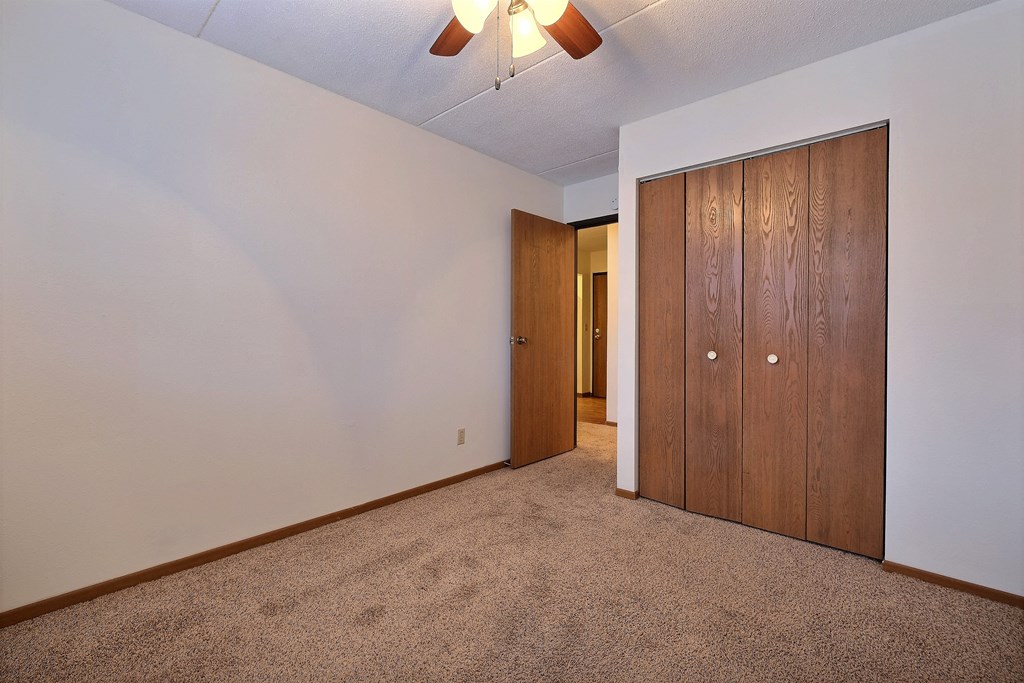 a bedroom with a closet and a door to a hallway. at France, North Dakota