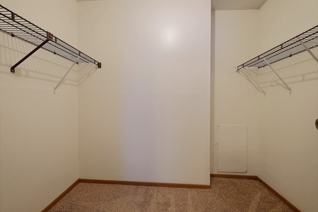 a room with two hanging racks on the wall and a closet at France, Fargo, 58103