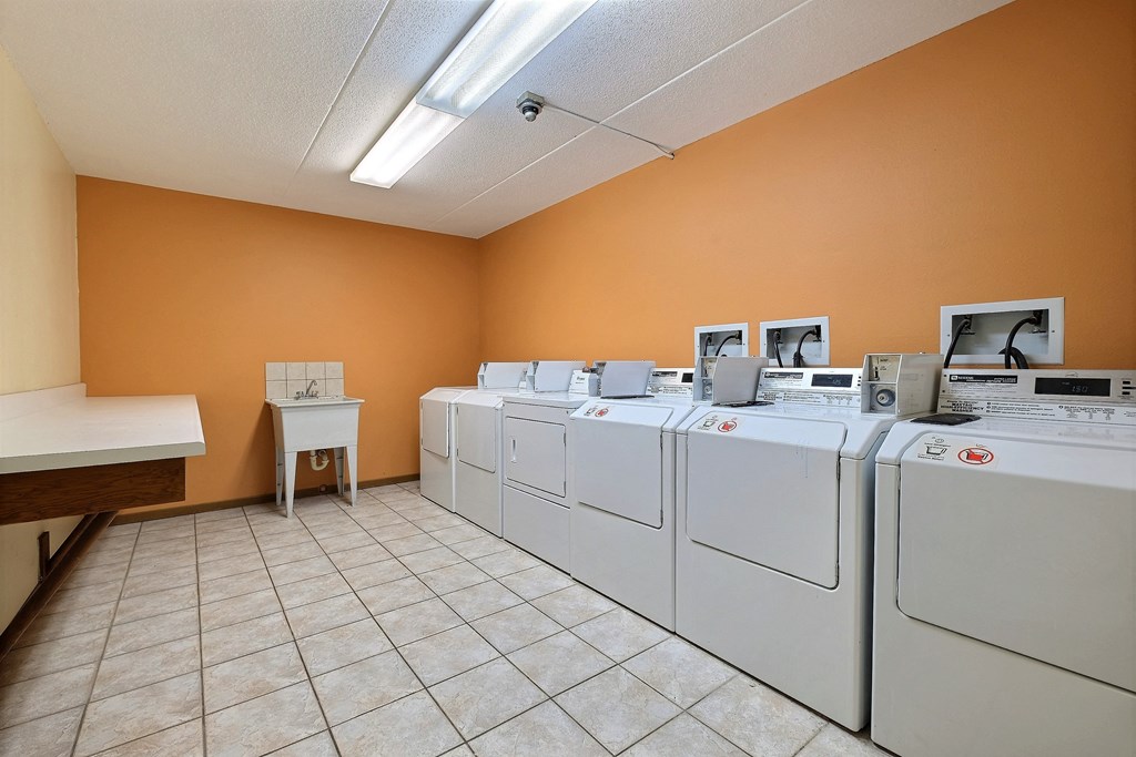 a row of washers and dryers in a laundry room at France, Fargo North Dakota