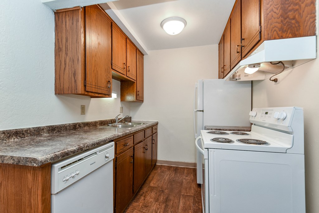 White Bear Lake, MN White Bear Terrace Apartments.  a kitchen with white appliances and wooden cabinets