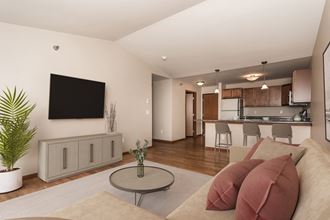 Grand Forks, ND Sterling Pointe Apartments. a living room with a couch and a table - Photo Gallery 4