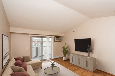 Grand Forks, ND Sterling Pointe Apartments. a living room with a couch and a tv on the wall