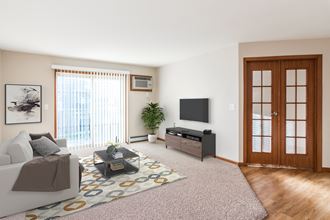 Grand Forks, ND Sterling Pointe Apartments. a living room with a white couch and a tv on the wall - Photo Gallery 5