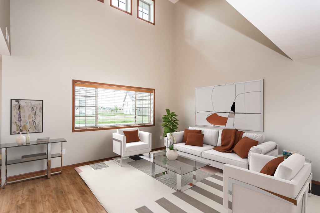 a living room with a white couch and a glass coffee table  at Sterling Pointe, Grand Forks