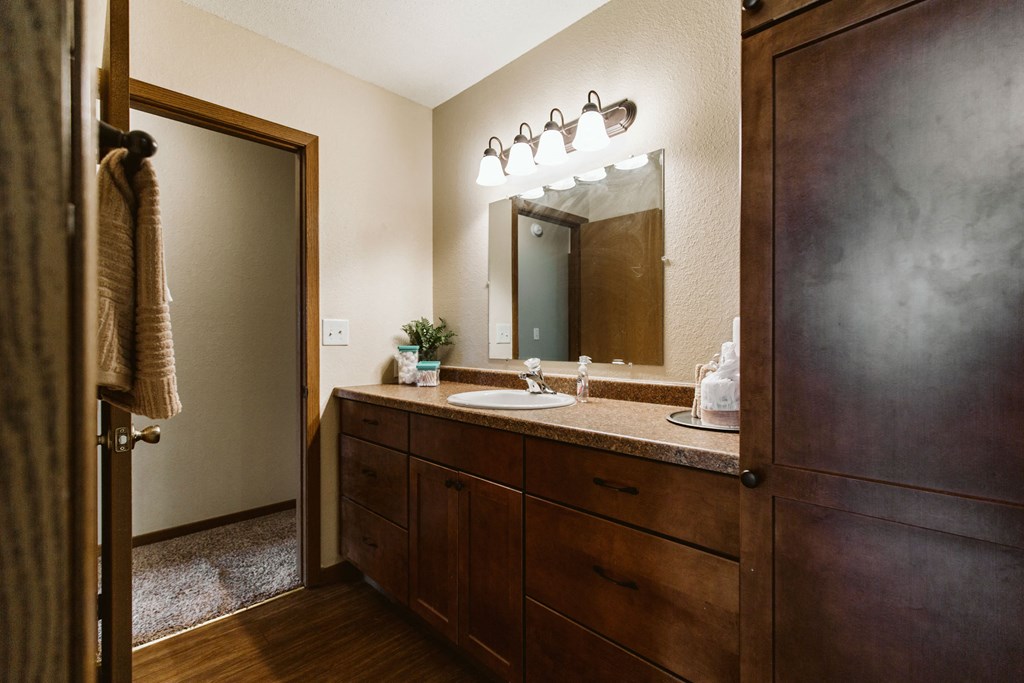 Grand Forks, ND Grandview II Apartments. A bathroom with a sink and dark cabinets