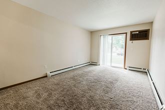 Grand Forks, ND Grandview II Apartments. A living room with a glass sliding door