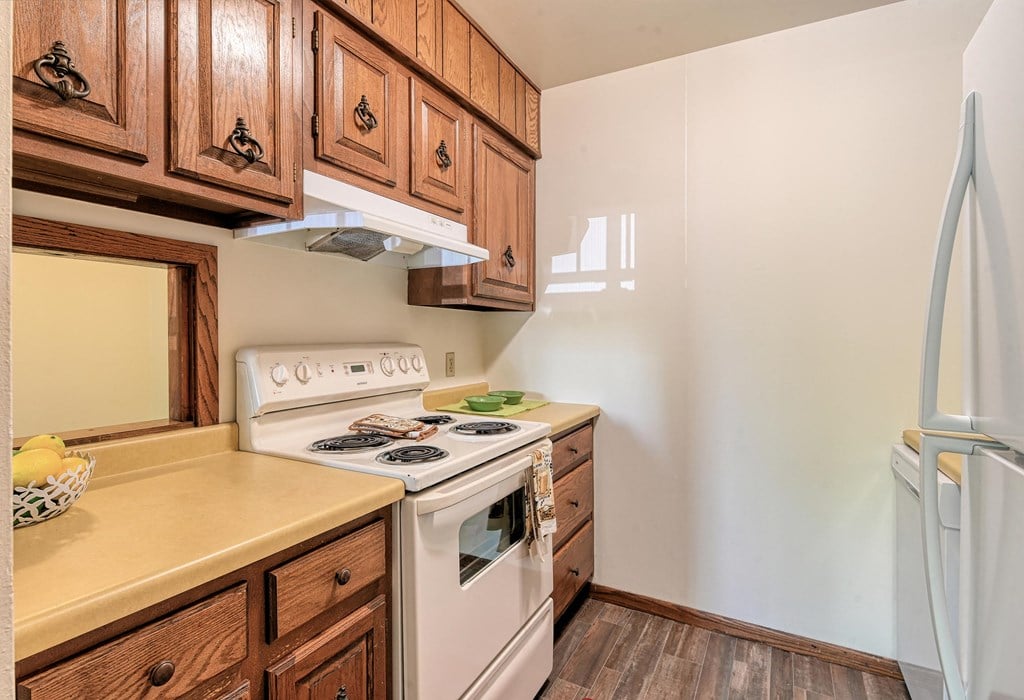 Grand Forks, ND Roughrider Apartments. A kitchen with white appliances.