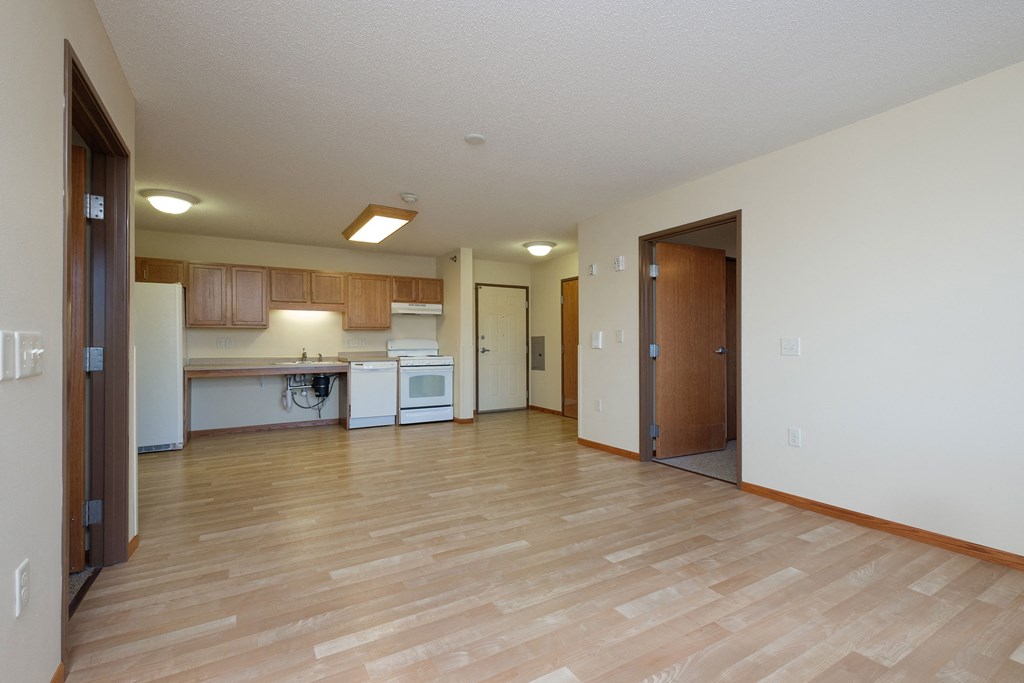 a kitchen and living room with wood floors. Fargo, ND Crossroads Apartments