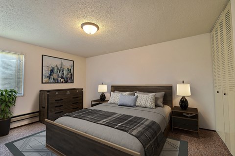 Fargo, ND Kingswood Apartments. a bedroom with a bed with night stands and a dresser.