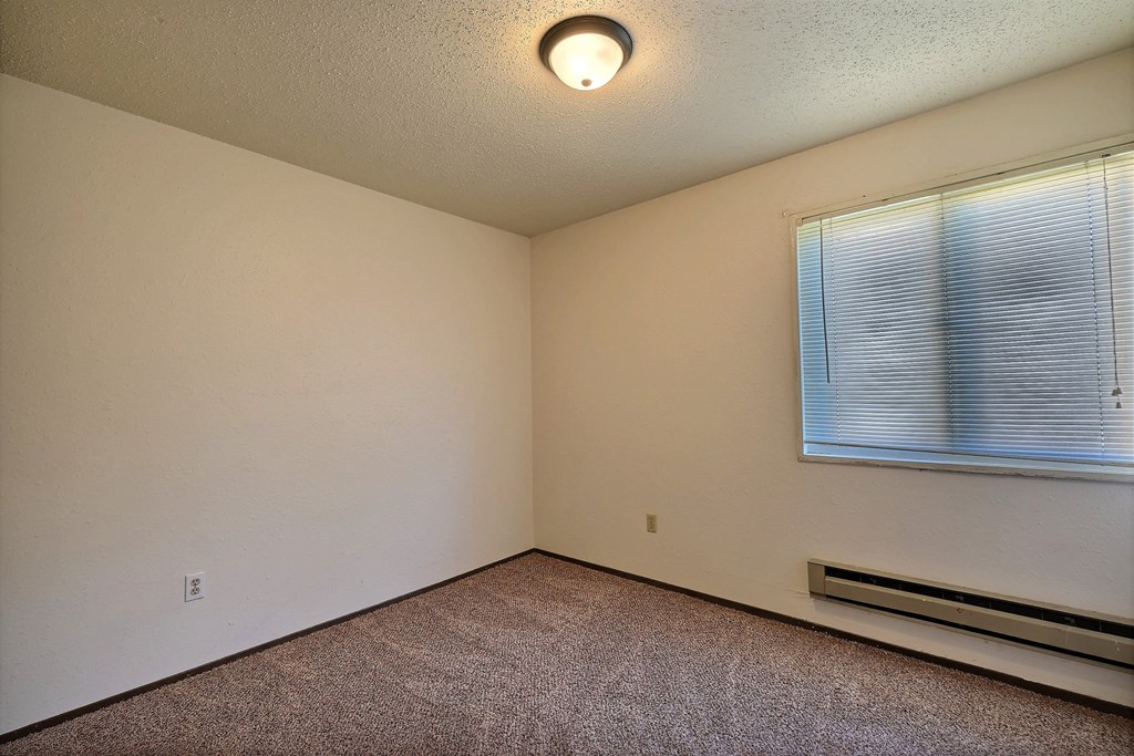 a bedroom with a large window