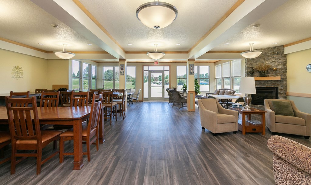 a community room with tables and chairs. Fargo, ND Sunrise North
