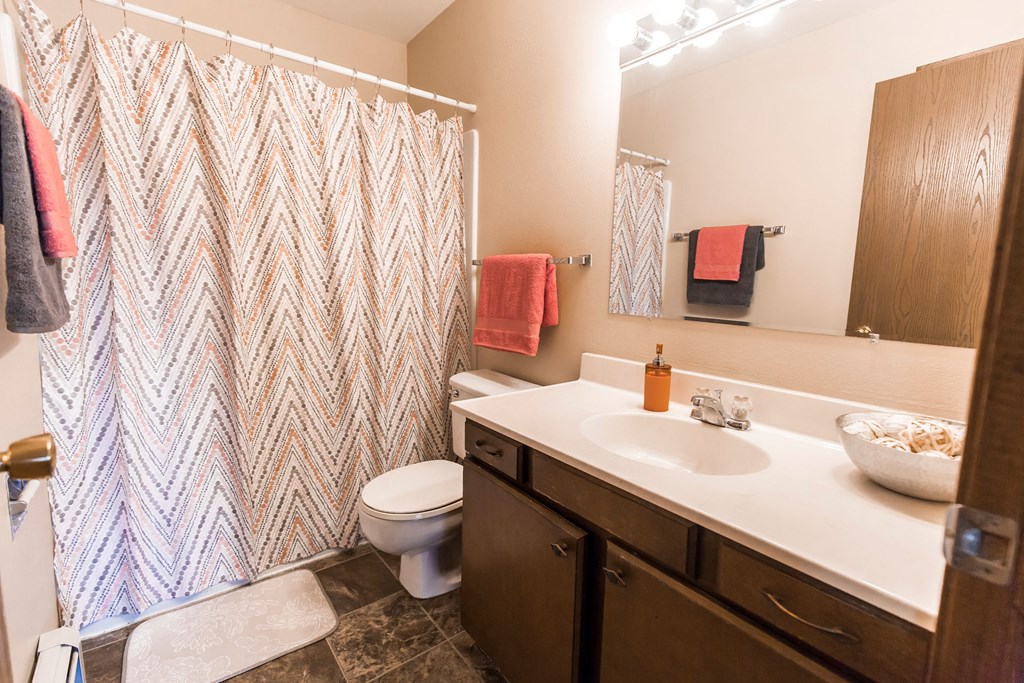 Grand Forks, ND Mayfair Apartments a bathroom with a toilet sink and shower