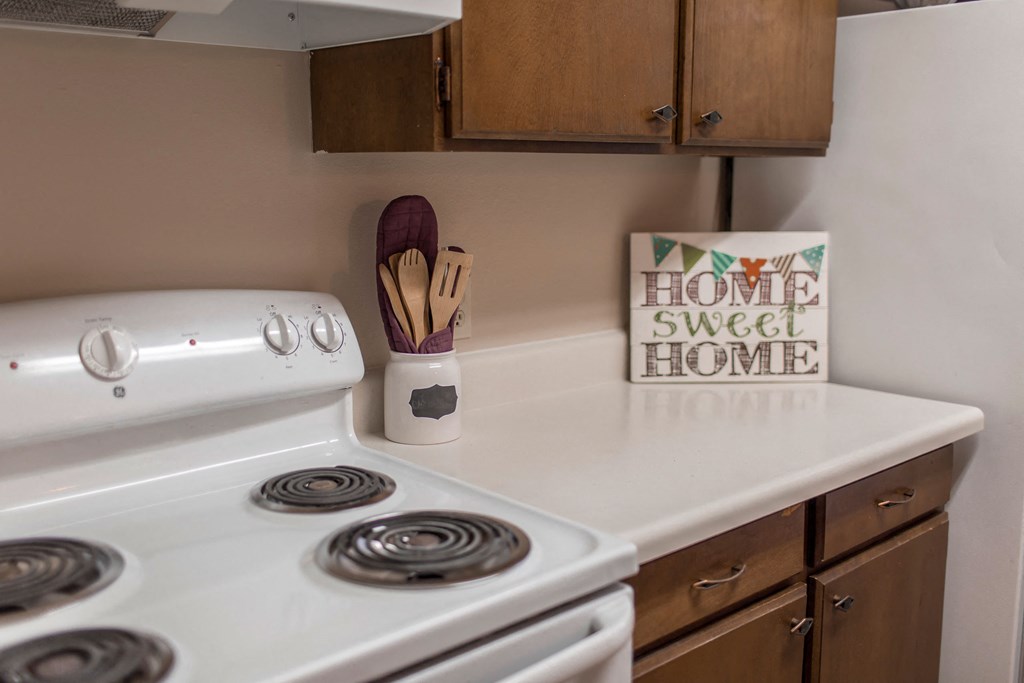 Grand Forks, ND Mayfair Apartments a kitchen with a stove and cabinets