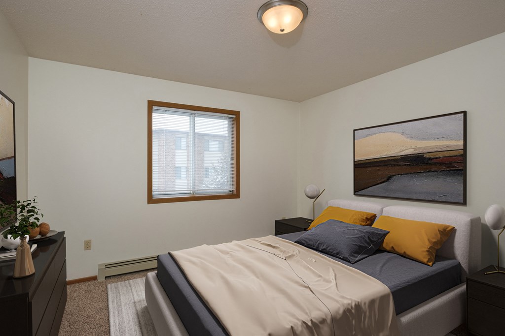 Fargo, ND Park Circle Apartments. a bedroom with a bed and a dresser