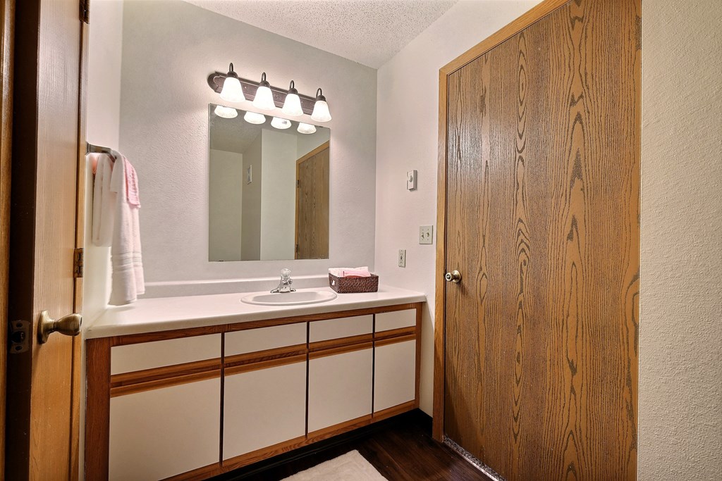 Bathroom with sink and mirror at Park Place Apartments in Fargo, ND