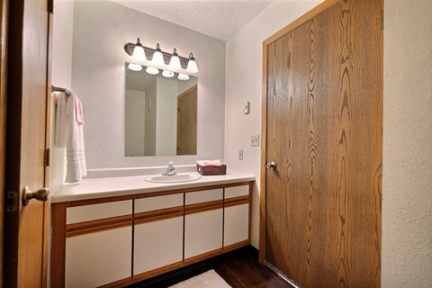 Bathroom with sink and mirror at Park Place Apartments in Fargo, ND