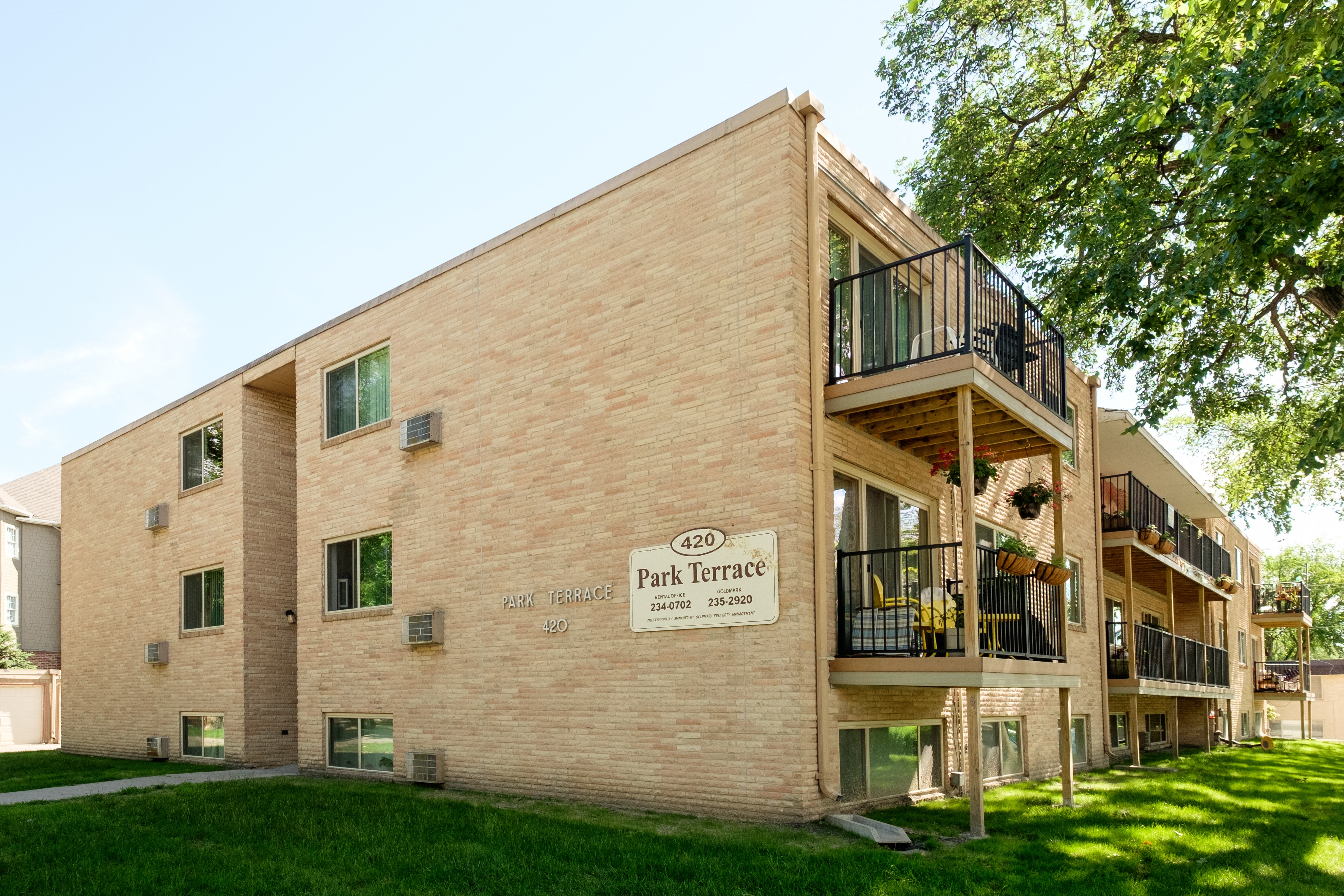 the exterior of a three level building. Fargo, ND Park Terrace Apartments