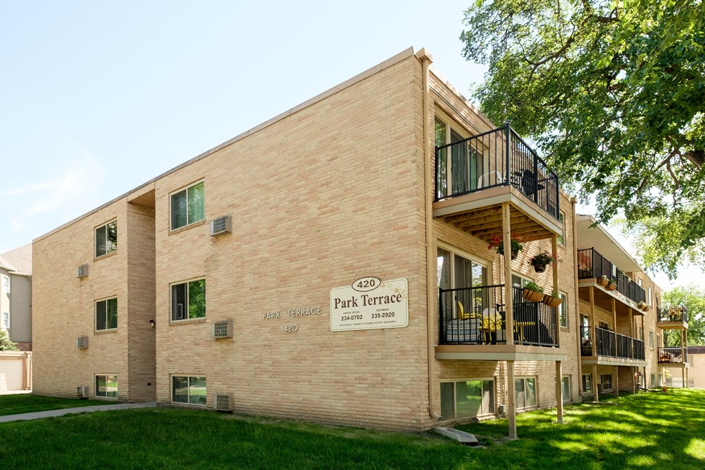 the exterior of a three level building. Fargo, ND Park Terrace Apartments