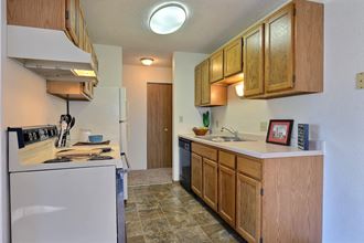 A kitchen with white appliances. Fargo, ND Place One Apartments.