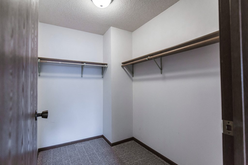 Grand Forks Primrose Apartments. A small room with a white wall and a wooden door