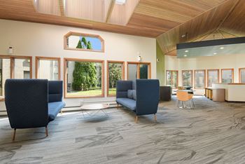 The Edge of Uptown Apartments | Atrium with comfortable chairs