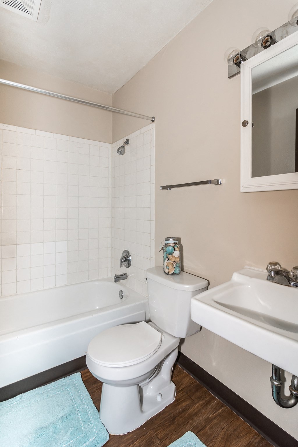 Grand Forks, ND Riverwood Apartments. A bathroom with a toilet and a sink and a tub