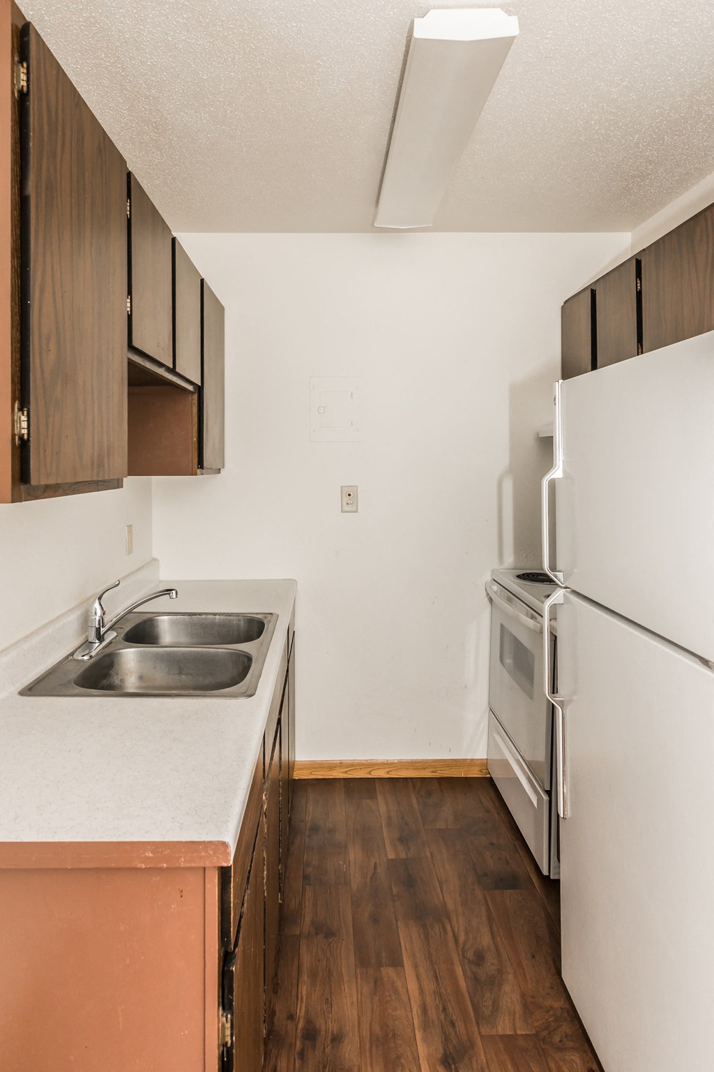 Grand Forks, ND Riverwood Apartments. A kitchen with a sink and a refrigerator