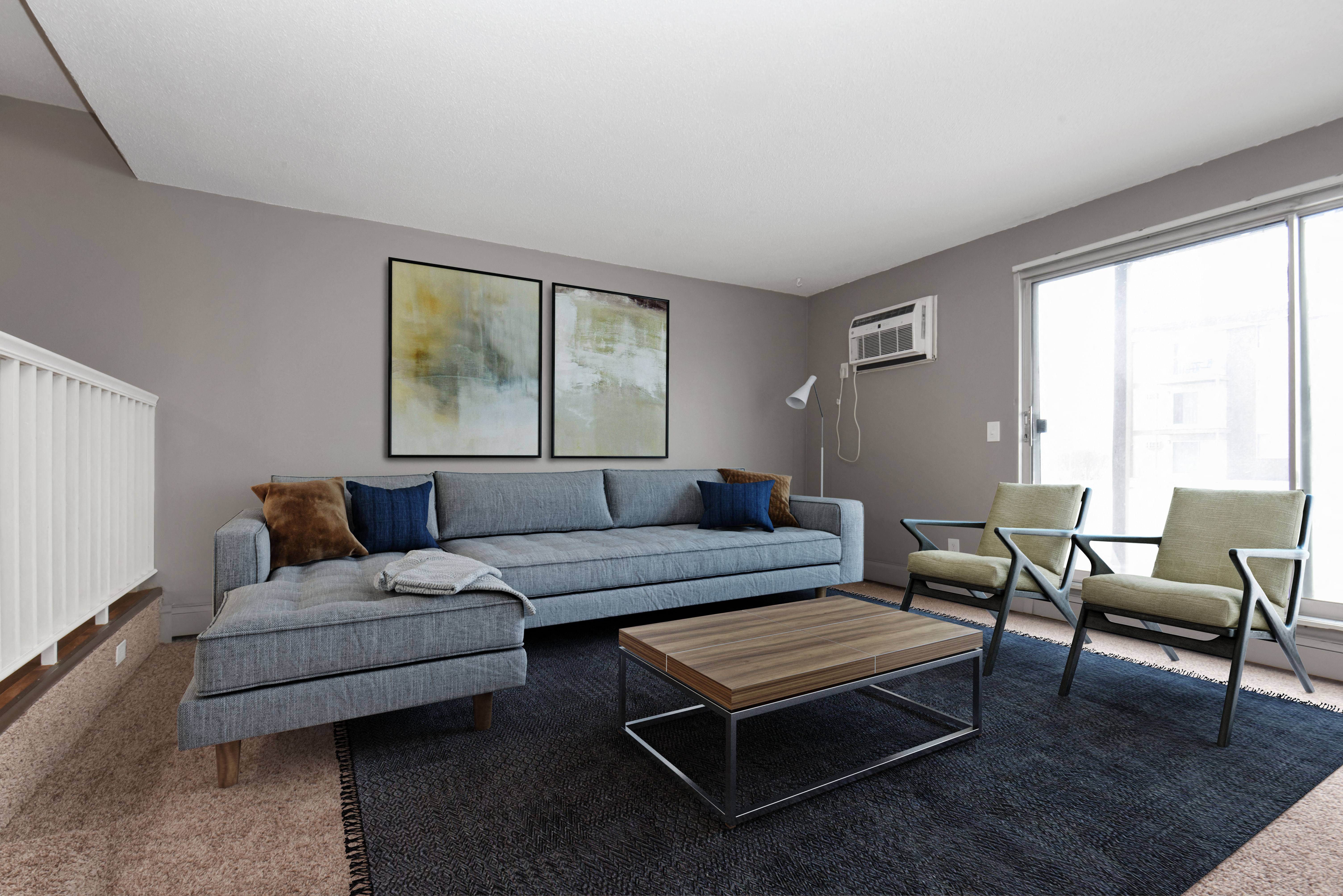 a living room with grey couches and a coffee table