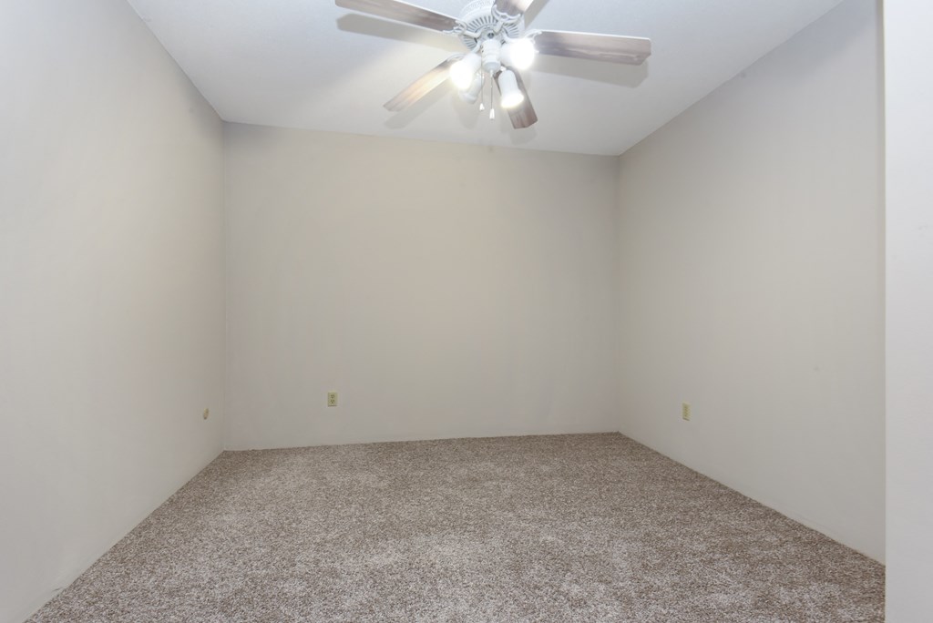 an empty room with white walls and a ceiling fan. Roseville, MN Rosedale Estates