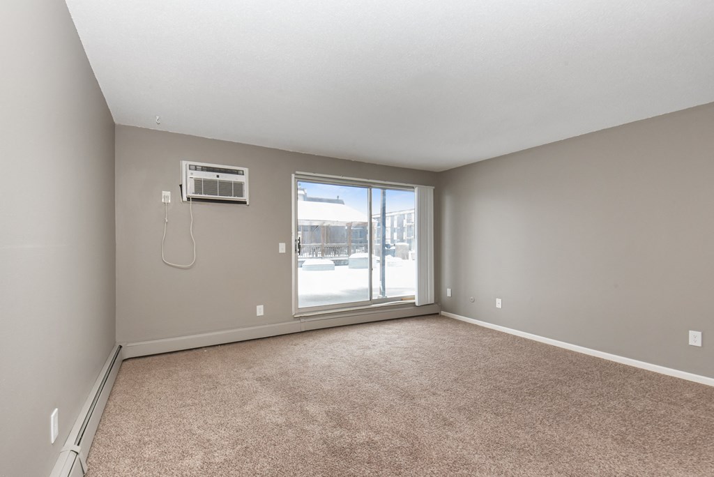 an empty living room with a large window. Roseville, MN Rosedale Estates