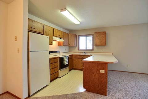 a kitchen with a white refrigerator and a counter top