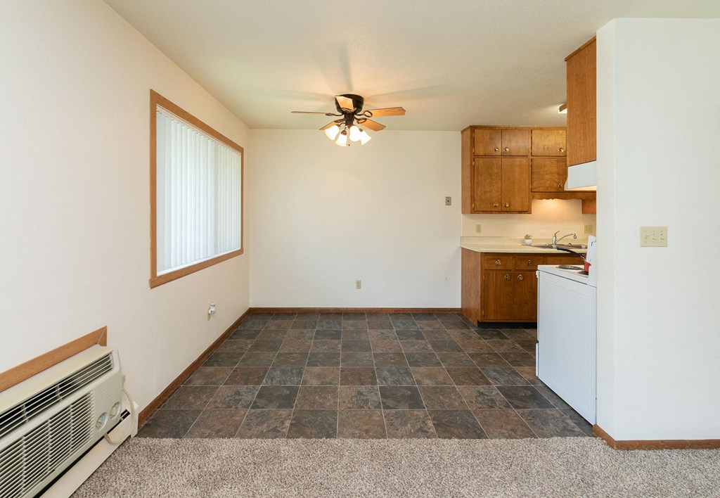 a dining room with a window and ceiling fan. Fargo, ND Islander Apartments