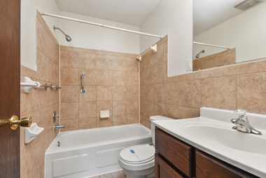 a bathroom with a toilet sink and bathtub - Photo Gallery 5