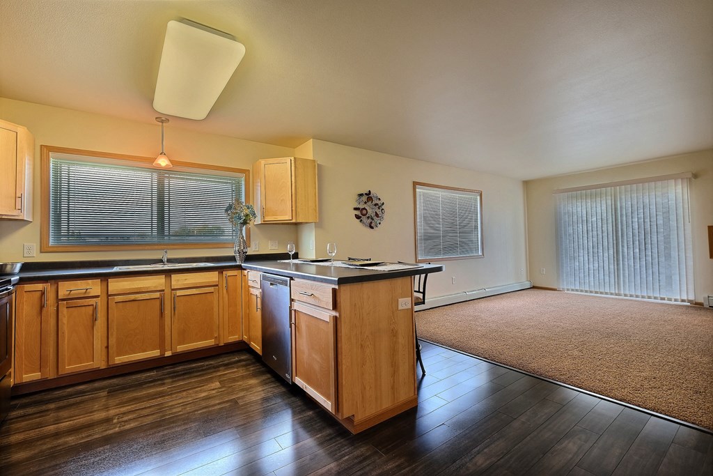 a kitchen with wooden cabinets and a counter top. Moorhead, MN Sandy Creek Apartments