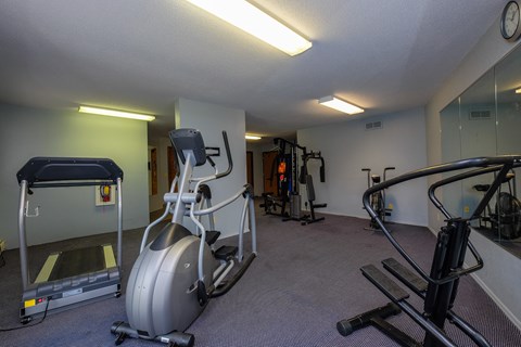 a gym with treadmills and other exercise equipment. Fargo, ND South Pointe Apartments