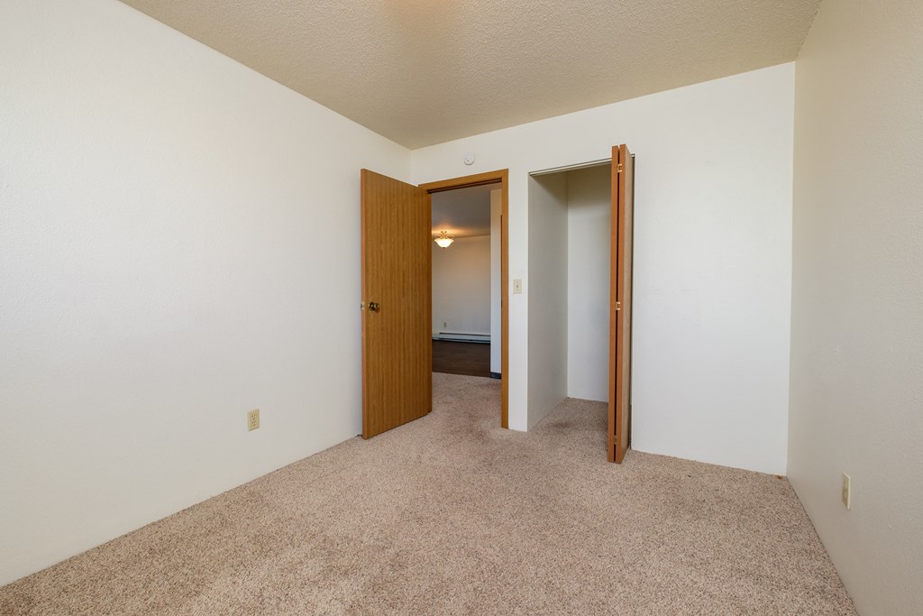 a bedroom with a closet. Fargo, ND South Pointe Apartments