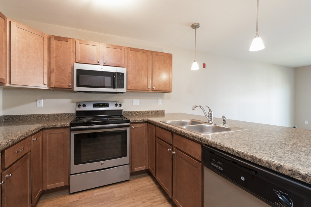 Kitchen with Microwave and Stove at Stonefield Apartments in Bismarck, ND