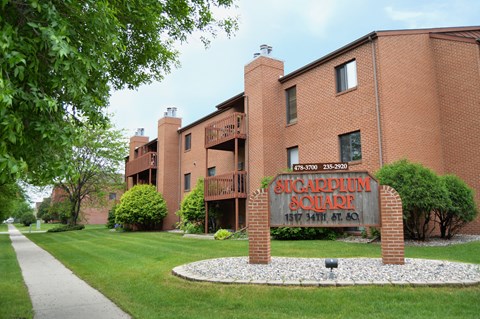 a large brick building with a sign in front of it