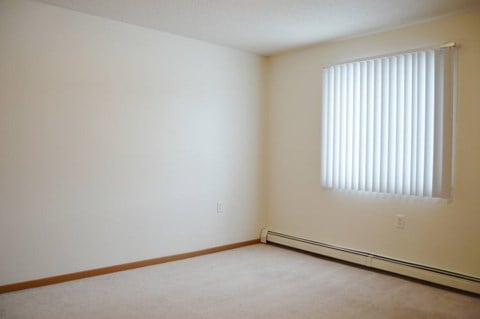 an empty room with a window and white walls.  Fargo, ND Summit Point Apartments