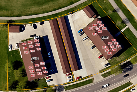 an aerial view of a parking lot with street signs