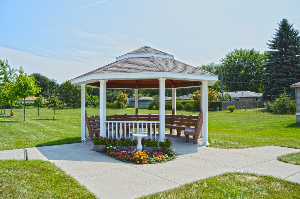 a gazebo with flowers and a large grassy area. Fargo, ND Sunrise North