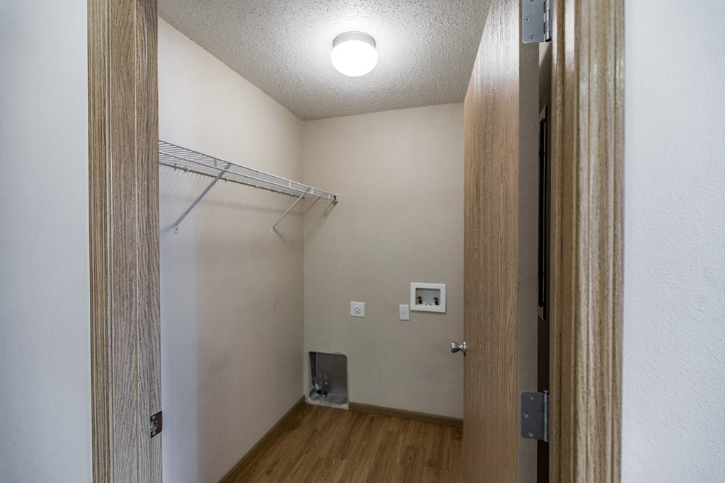 Empty room with a closet and a door to a bathroom at Sunset Ridge Apartments in Bismarck