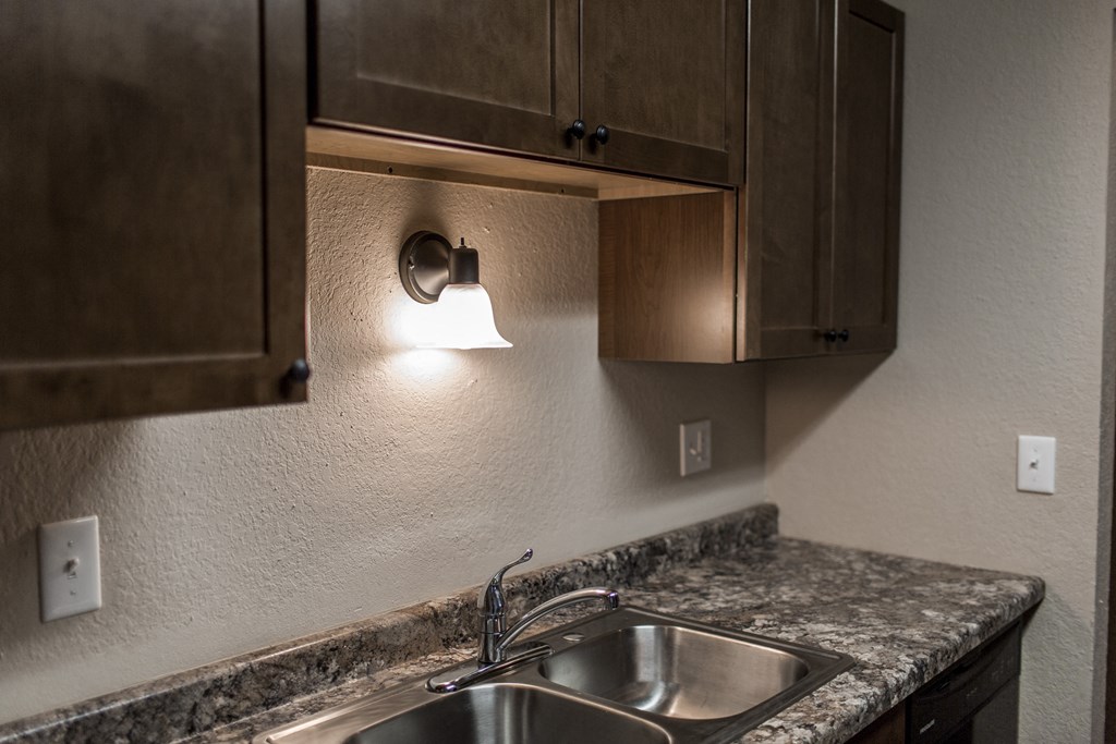 Grand Forks, ND Sunview Apartments | Kitchen Grand Forks, ND Sunview Apartments. A close up of a sink with a light above it.