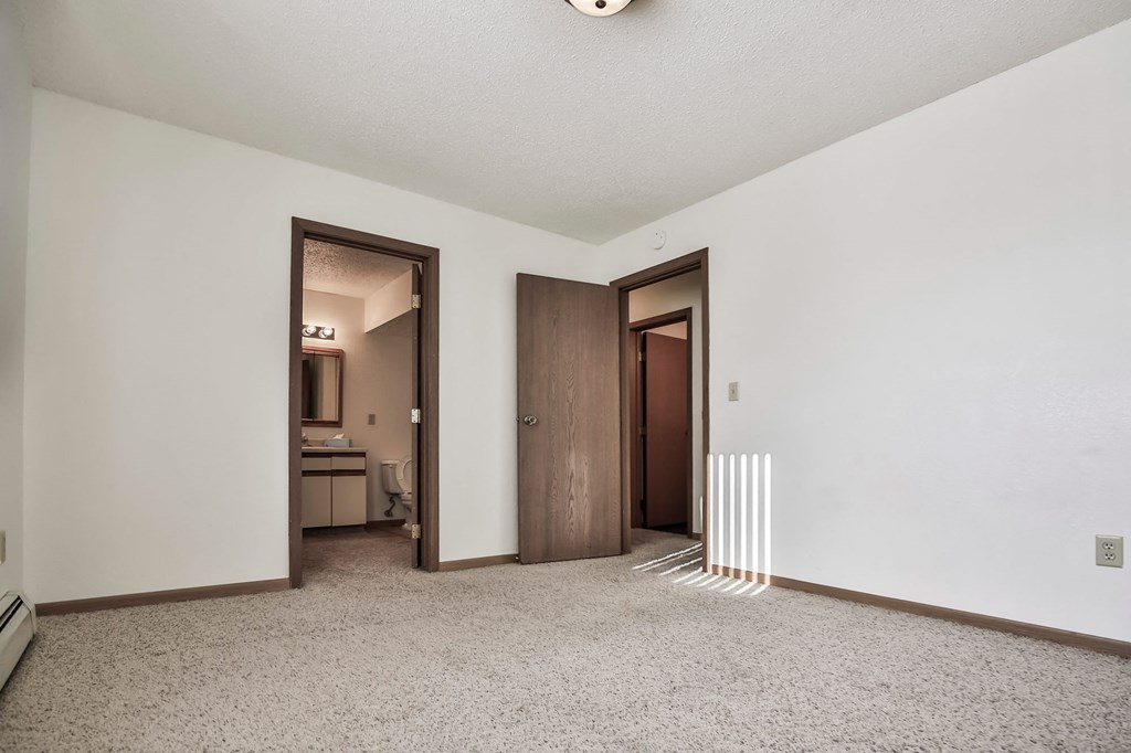 Grand Forks, ND Sunview apartments. a living room with white walls and a carpeted floor