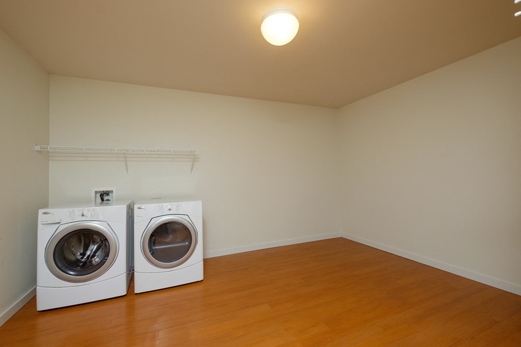 a laundry room with two washers and a dryer. Fargo, ND Thunder Creek Apartments