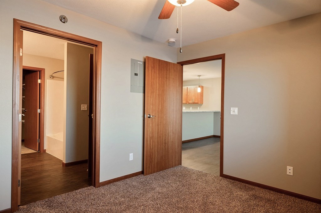 a bedroom and the bathroom. Fargo, ND Urban Plains Apartments