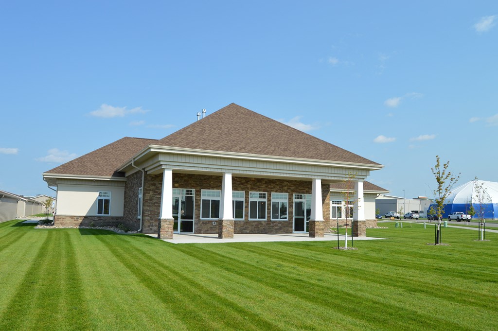 a building with a lawn in front of it. Fargo, ND Urban Plains Apartments
